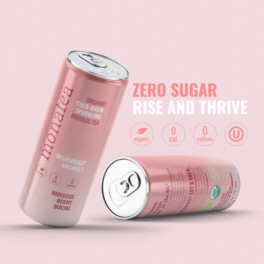 Two pink cans of Monalisa Zero Sugar organic cold-pressed sparkling rooibos tea on a light pink background.